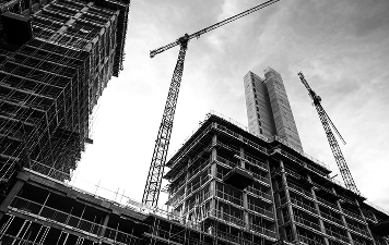 Cranes and under-construction building